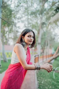 Indyword.com - Mini Crossword 80 - Woman Poses in a Pink Saree